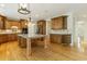 Open kitchen with custom cabinetry, a large island with granite countertop, and stainless steel appliances at 1565 Briergate Dr, Duluth, GA 30097