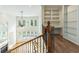 Open-concept living area with hardwood floors, built-in shelving, and ample natural light at 1565 Briergate Dr, Duluth, GA 30097