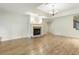 Living room with wood flooring, fireplace and neutral paint, creating a cozy space at 1565 Briergate Dr, Duluth, GA 30097