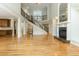 Bright living room features an open layout, hardwood floors, staircase, and a fireplace with built-in shelving at 1565 Briergate Dr, Duluth, GA 30097