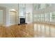 Bright living room boasts hardwood floors, large windows, a marble fireplace and built-in shelving at 1565 Briergate Dr, Duluth, GA 30097