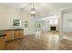 Bright living room featuring wood flooring, light wood cabinets with sink, and a cozy fireplace at 1565 Briergate Dr, Duluth, GA 30097