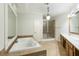 Luxurious main bathroom with soaking tub, dual sinks, shower, and tile floor at 1565 Briergate Dr, Duluth, GA 30097