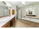 Elegant main bathroom with dual sinks, large soaking tub, and tiled floor at 1565 Briergate Dr, Duluth, GA 30097