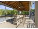 Covered outdoor bar featuring ceiling fans overlooking the tennis court at 1565 Briergate Dr, Duluth, GA 30097