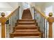 Beautiful staircase features wood treads, white risers, and decorative wrought iron spindles at 1565 Briergate Dr, Duluth, GA 30097