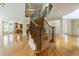 Staircase featuring hardwood floors, iron railings, and an open view to the kitchen at 1565 Briergate Dr, Duluth, GA 30097