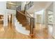 Elegant staircase featuring hardwood floors, iron railings, and an open view to the living area at 1565 Briergate Dr, Duluth, GA 30097