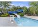 Fun water slide feature with a small pool and tables with umbrellas for a pleasant day at the community pool at 1565 Briergate Dr, Duluth, GA 30097