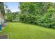 A spacious backyard boasting mature trees and a large grassy area at 2720 Birchwood Sw Way, Marietta, GA 30060