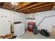 Basement laundry area with white and red appliances and exposed utilities at 2720 Birchwood Sw Way, Marietta, GA 30060