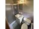 Standard bathroom featuring a shower, sink, toilet and an overhead vanity light at 2720 Birchwood Sw Way, Marietta, GA 30060
