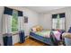 Cozy bedroom with hardwood floors, natural light, and blue accents at 2720 Birchwood Sw Way, Marietta, GA 30060