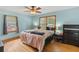 Comfortable bedroom featuring wood floors, ceiling fan and natural light at 2720 Birchwood Sw Way, Marietta, GA 30060