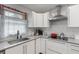 Clean kitchen with white cabinets, subway tile backsplash and stainless steel range hood at 2720 Birchwood Sw Way, Marietta, GA 30060