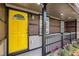 Welcoming covered porch featuring a bright yellow door and decorative black railings at 2760 Swansea Ct, College Park, GA 30349