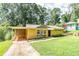 Charming brick home with well-manicured lawn, mature trees, and inviting carport at 3467 Pinehill Dr, Decatur, GA 30032