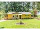 Charming brick home with well-manicured lawn, mature trees, and inviting carport at 3467 Pinehill Dr, Decatur, GA 30032