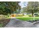 Inviting home with expansive lawn, mature trees, and a welcoming, covered carport at 3467 Pinehill Dr, Decatur, GA 30032