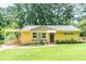Charming brick home with well-manicured lawn, mature trees, and inviting carport at 3467 Pinehill Dr, Decatur, GA 30032