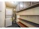 Functional laundry room with washer, dryer, water heater, and storage shelves at 3467 Pinehill Dr, Decatur, GA 30032