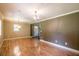 Bright living room featuring hardwood floors, crown molding, and elegant chandelier lighting at 3467 Pinehill Dr, Decatur, GA 30032
