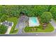 Aerial view of community pool and clubhouse with parking lot surrounded by mature trees at 4178 Mcever Park Dr, Acworth, GA 30101