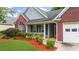 Charming single-Gathering home with brick and siding exterior, a manicured lawn, and attached garage at 4178 Mcever Park Dr, Acworth, GA 30101