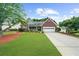 Charming brick home with a well-manicured lawn and a two-car garage at 4178 Mcever Park Dr, Acworth, GA 30101