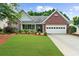 Charming brick home featuring a manicured lawn and a two-car garage at 4178 Mcever Park Dr, Acworth, GA 30101