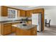 Bright kitchen with granite countertops, a kitchen island and wood cabinets that leads into a dining area at 4178 Mcever Park Dr, Acworth, GA 30101