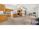 Bright, open-concept kitchen with wood cabinets, granite counters, and an island, flowing into the living area at 4178 Mcever Park Dr, Acworth, GA 30101