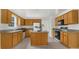 Well-lit kitchen featuring granite countertops, wood cabinetry, and a functional island with ample counter space at 4178 Mcever Park Dr, Acworth, GA 30101