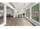 Bright living room with large windows, carpeted floors, and a view into the next room with a cozy gray sofa at 4178 Mcever Park Dr, Acworth, GA 30101