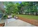 Cozy patio area with outdoor seating and a view of the well-maintained, expansive backyard with lush green grass at 4178 Mcever Park Dr, Acworth, GA 30101