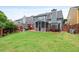 Spacious backyard with a screened-in porch, pergola, and grassy area at 4312 Shillham Ct, Cumming, GA 30040