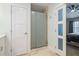 Bathroom including glass enclosed shower, toilet, tile floors and a doorway to the bedroom at 4312 Shillham Ct, Cumming, GA 30040