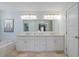 Bathroom featuring double vanity, large mirror, stylish fixtures, and separate tub and shower at 4312 Shillham Ct, Cumming, GA 30040