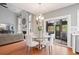 Open dining space leading from living area to screened porch with modern hanging light at 4312 Shillham Ct, Cumming, GA 30040