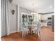 Charming dining area with modern chandelier, hardwood floors, and access to screened porch at 4312 Shillham Ct, Cumming, GA 30040