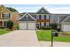 Charming two-story home featuring a brick facade, blue siding, a well-manicured lawn, and a two-car garage at 4312 Shillham Ct, Cumming, GA 30040