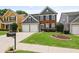 Attractive two-story home with a manicured lawn, mature landscaping, and a spacious driveway leading to a two-car garage at 4312 Shillham Ct, Cumming, GA 30040