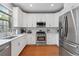 Clean kitchen with white cabinets, stainless appliances, and modern finishes at 4312 Shillham Ct, Cumming, GA 30040
