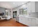 Bright eat-in kitchen with white cabinets, stainless steel appliances, and hardwood floors at 4312 Shillham Ct, Cumming, GA 30040