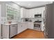 Bright kitchen with stainless steel appliances, modern countertops, and a window view at 4312 Shillham Ct, Cumming, GA 30040