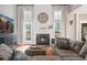 Cozy living room with a fireplace, large television, and comfortable seating area at 4312 Shillham Ct, Cumming, GA 30040