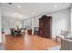 Spacious living room with hardwood floors, neutral walls, wainscoting, a dining table, and elegant furniture at 4312 Shillham Ct, Cumming, GA 30040