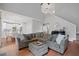Open concept living space with hardwood floors and a clear view to the modern kitchen at 4312 Shillham Ct, Cumming, GA 30040