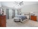Spacious main bedroom with plush carpeting, vaulted ceilings, ceiling fan and natural light at 4312 Shillham Ct, Cumming, GA 30040