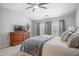 Comfortable main bedroom with carpet, TV, dresser, and ample natural light from windows at 4312 Shillham Ct, Cumming, GA 30040